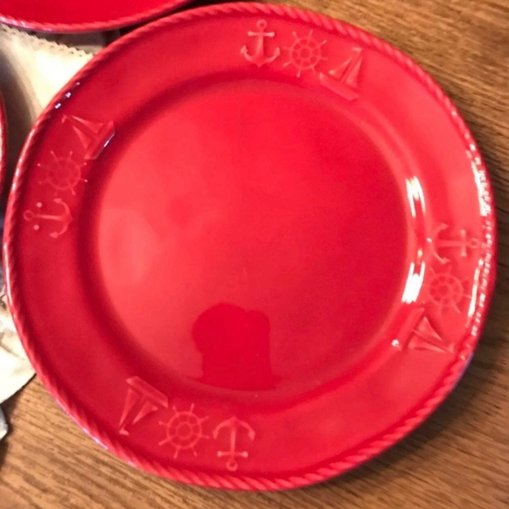 Red ceramic nautical dinner plate or service plate with raised anchor and wheel